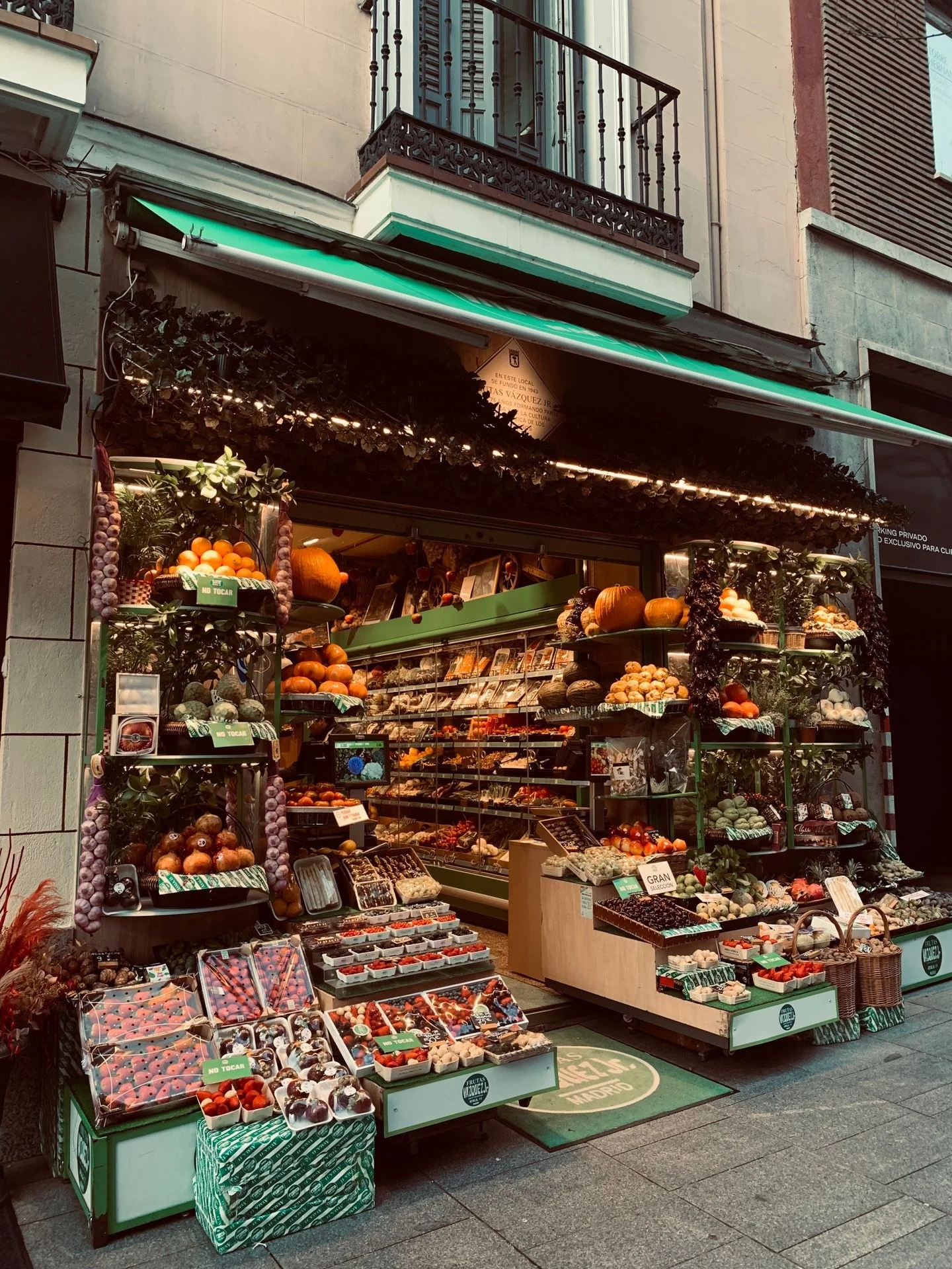 Vibrant street market stand with fresh, local fruits and vegetables on display.